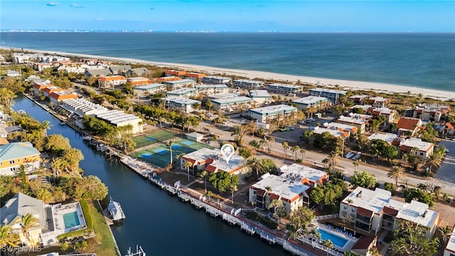 drone / aerial view featuring a water view and a view of the beach