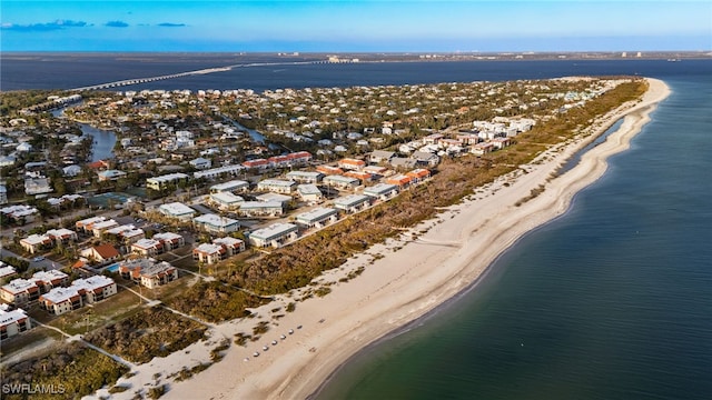 drone / aerial view with a water view and a beach view