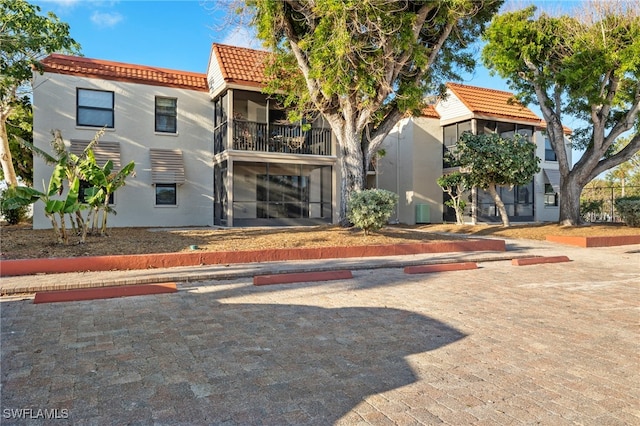 exterior space with a balcony and central AC unit