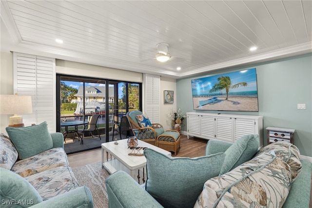 living room featuring hardwood / wood-style floors, ceiling fan, a raised ceiling, and wooden ceiling