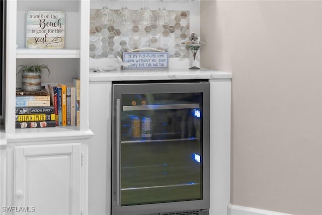 room details featuring bar area, beverage cooler, and backsplash