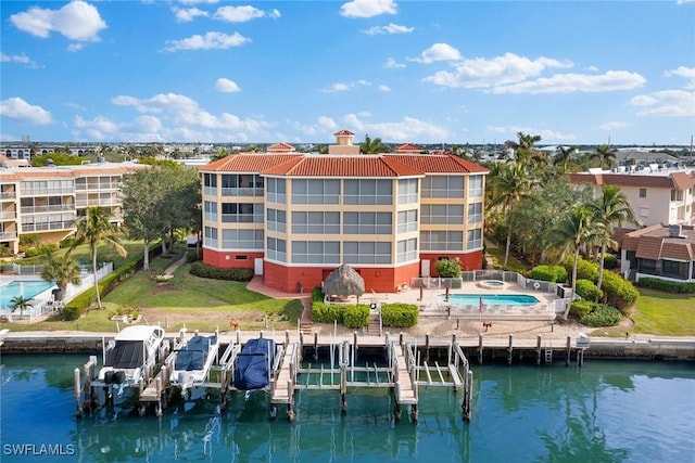 view of property with a water view and a community pool