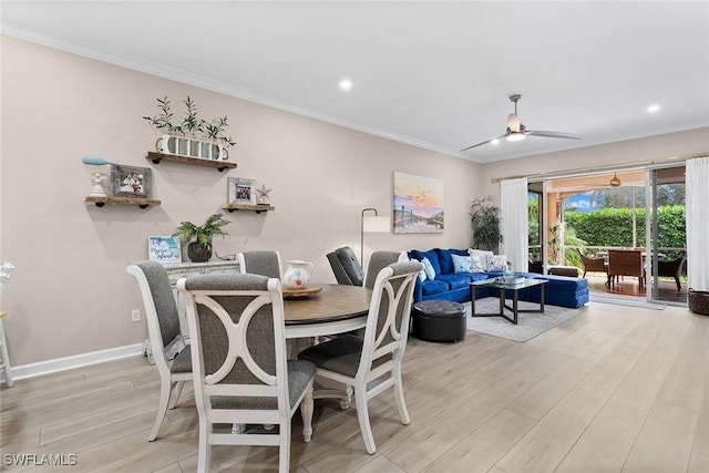 dining area featuring light hardwood / wood-style flooring, ceiling fan, and crown molding