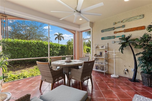 sunroom / solarium featuring ceiling fan