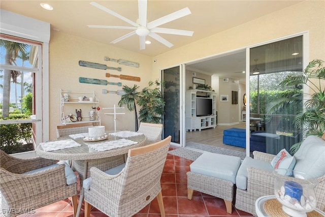 sunroom / solarium featuring ceiling fan