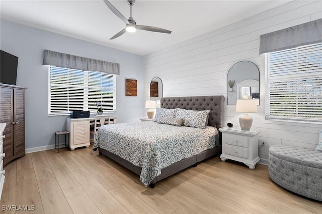 bedroom with ceiling fan and light hardwood / wood-style floors