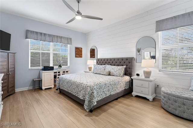 790 W Elkcam Cir Unit 103, Marco Island, FL 34145 - bedroom with baseboards, ceiling fan, light wood finished floors, and wood walls