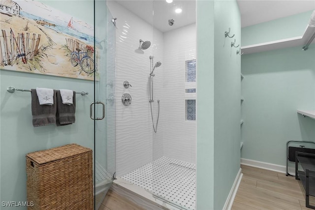 bathroom featuring wood-type flooring and an enclosed shower