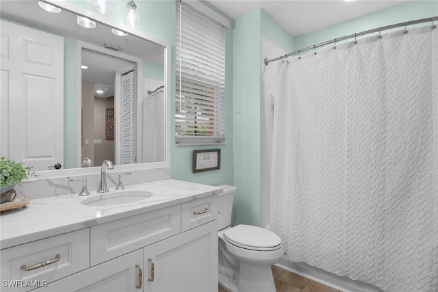 bathroom featuring hardwood / wood-style floors, vanity, and toilet