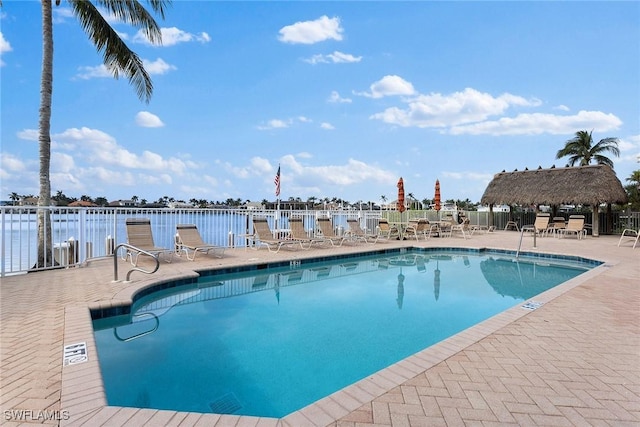 view of swimming pool with a gazebo, a water view, and a patio area