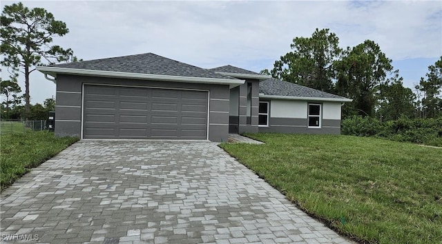 view of front facade featuring a garage and a front lawn