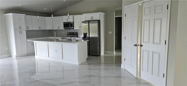 kitchen with pendant lighting, white cabinetry, an island with sink, decorative backsplash, and stainless steel appliances