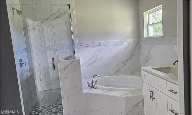 bathroom with vanity and separate shower and tub