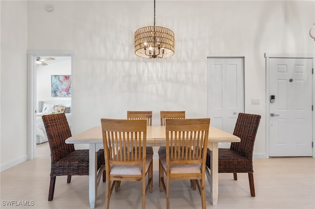 dining area featuring light hardwood / wood-style flooring and a notable chandelier