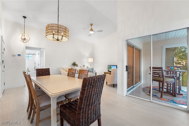 dining area featuring ceiling fan with notable chandelier and light hardwood / wood-style flooring