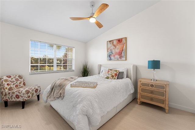 bedroom featuring ceiling fan, lofted ceiling, and light hardwood / wood-style flooring