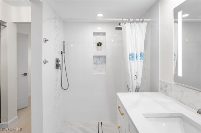 bathroom featuring curtained shower and vanity