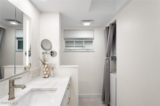 bathroom featuring vanity and stacked washer and dryer