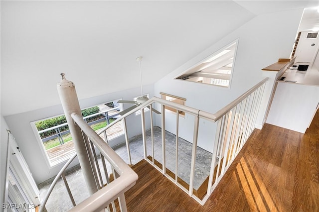 stairs with lofted ceiling and wood-type flooring