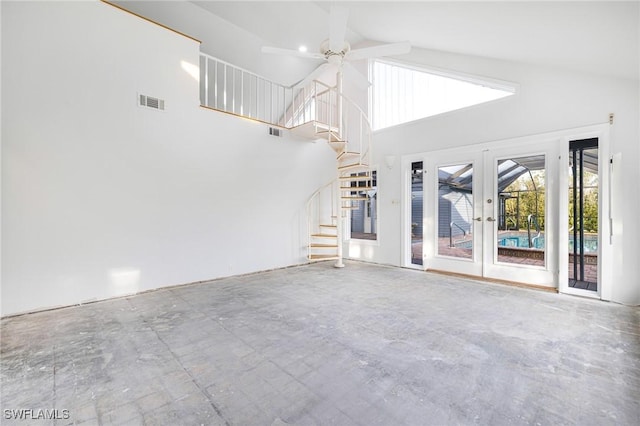 unfurnished living room with french doors, high vaulted ceiling, and ceiling fan