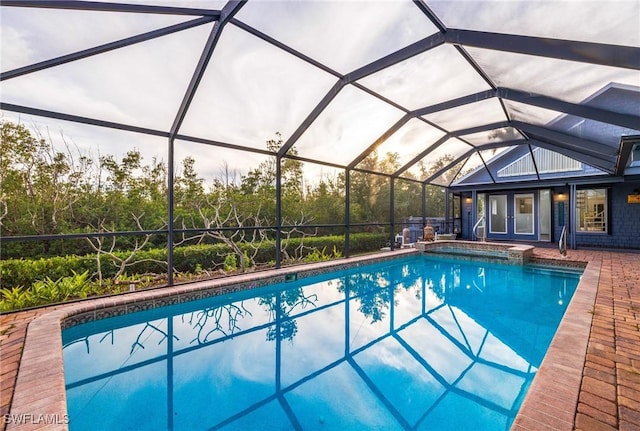 view of swimming pool featuring a lanai and a patio area