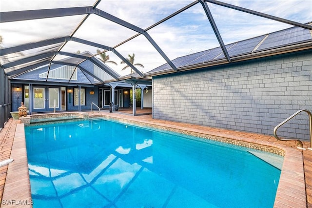 view of pool featuring a lanai, a patio, and french doors