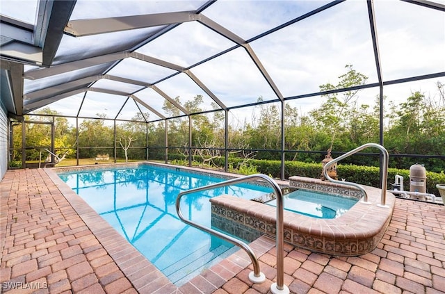 view of swimming pool featuring an in ground hot tub, a patio area, and a lanai