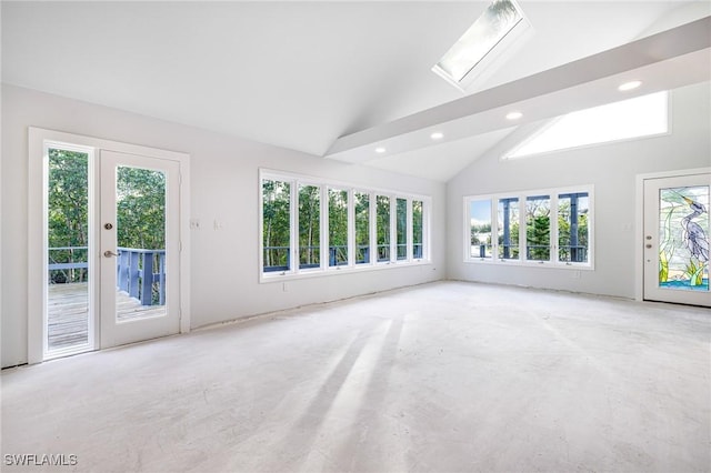 spare room featuring a skylight, high vaulted ceiling, and plenty of natural light