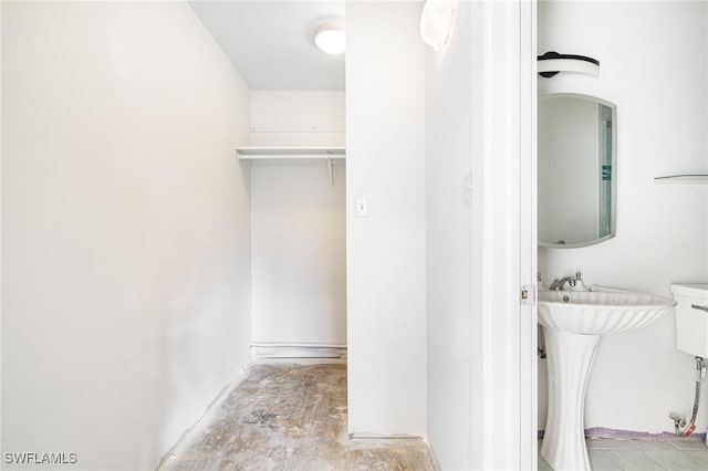 bathroom with sink and concrete floors