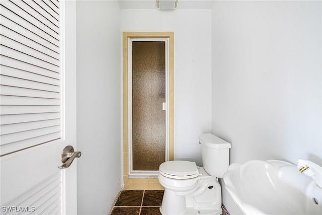 bathroom with tile patterned floors, toilet, and walk in shower