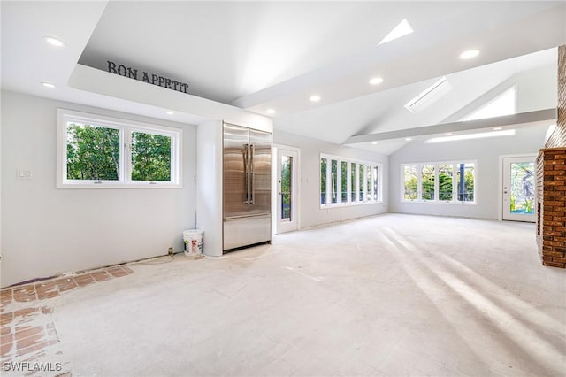 unfurnished living room with vaulted ceiling