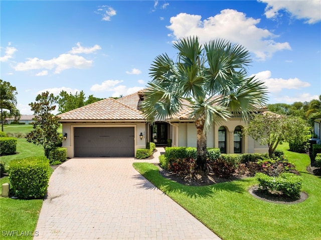 view of front of property featuring a front yard and a garage