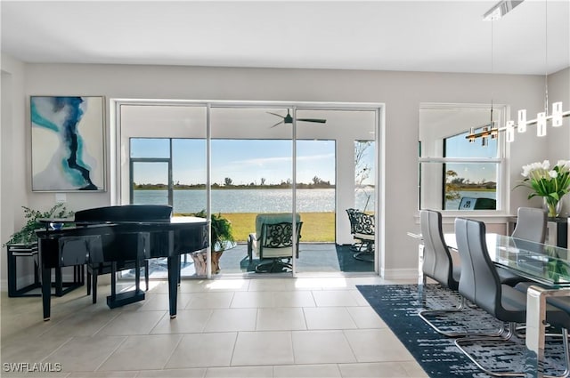 interior space featuring a water view and light tile patterned flooring