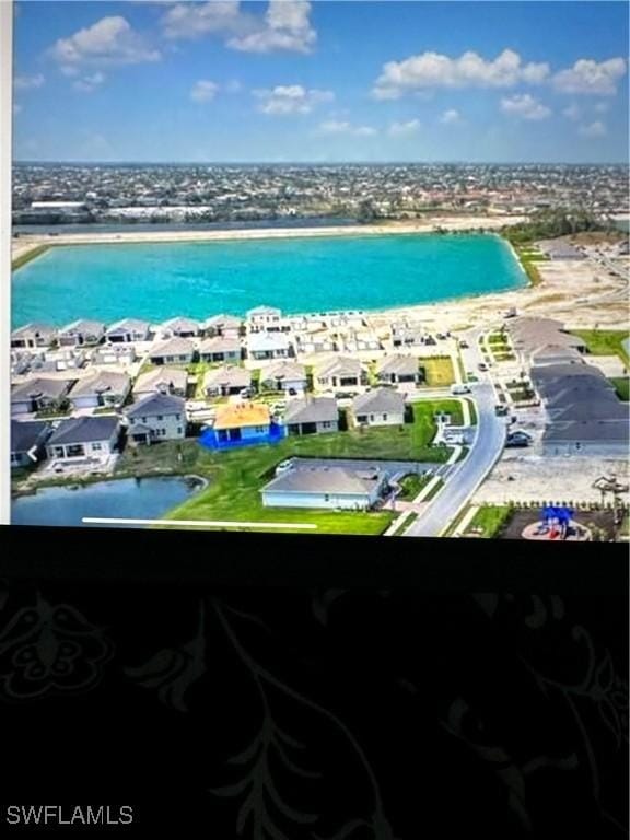 drone / aerial view featuring a residential view and a water view