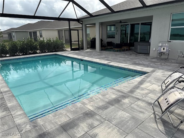 outdoor pool with a patio area, a lanai, outdoor lounge area, and a ceiling fan