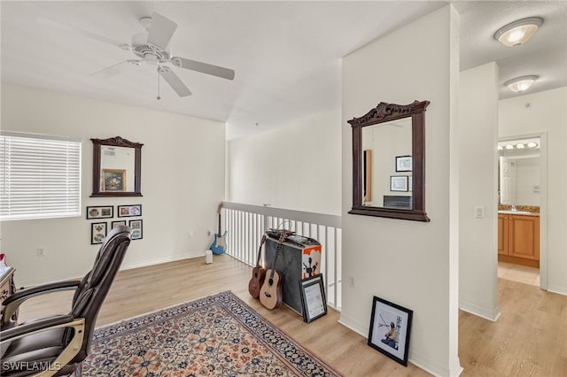 office space with light hardwood / wood-style flooring and ceiling fan