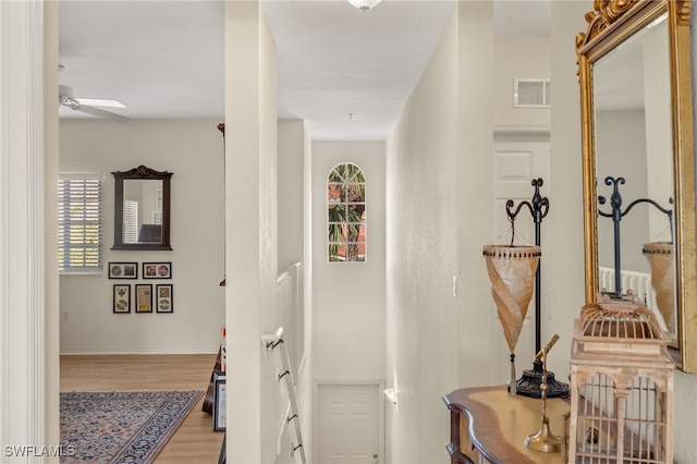 hallway with hardwood / wood-style floors