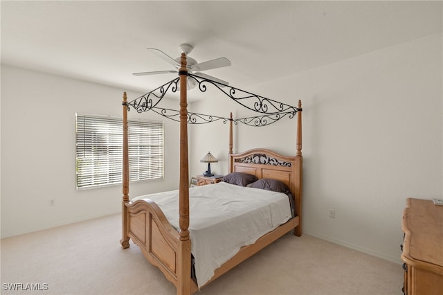 bedroom with light colored carpet and ceiling fan