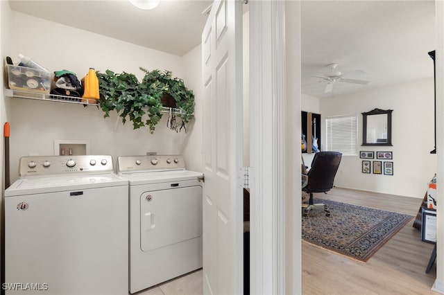 laundry area featuring light hardwood / wood-style flooring, washer and clothes dryer, and ceiling fan