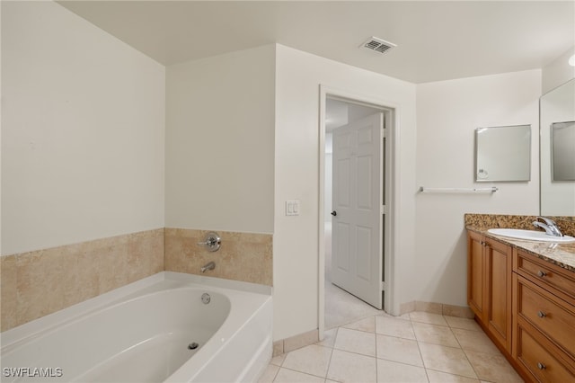 bathroom with vanity, tile patterned floors, and a bathtub