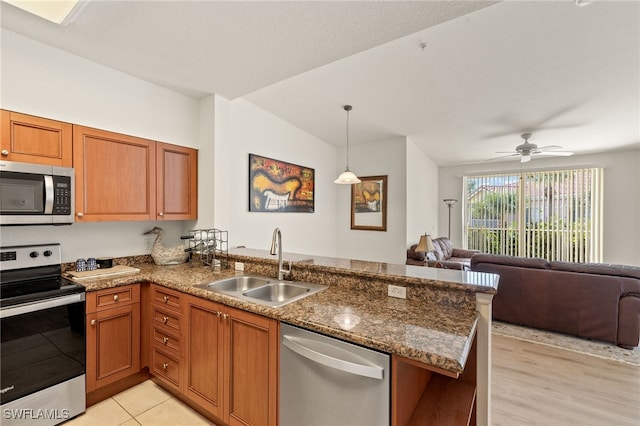 kitchen featuring kitchen peninsula, appliances with stainless steel finishes, ceiling fan, sink, and pendant lighting