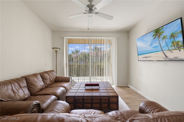 living room with light wood-type flooring and ceiling fan