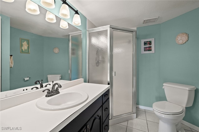 bathroom with toilet, vanity, tile patterned floors, and a shower with shower door