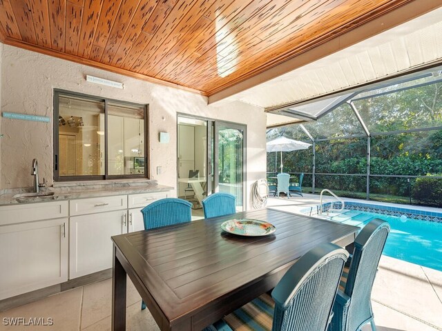 view of patio / terrace featuring a lanai and sink