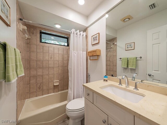 full bathroom with toilet, vanity, and shower / tub combo with curtain