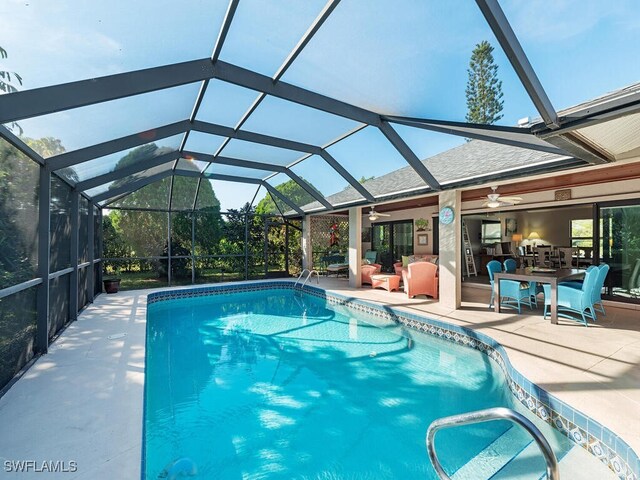 view of pool featuring ceiling fan, a lanai, and a patio