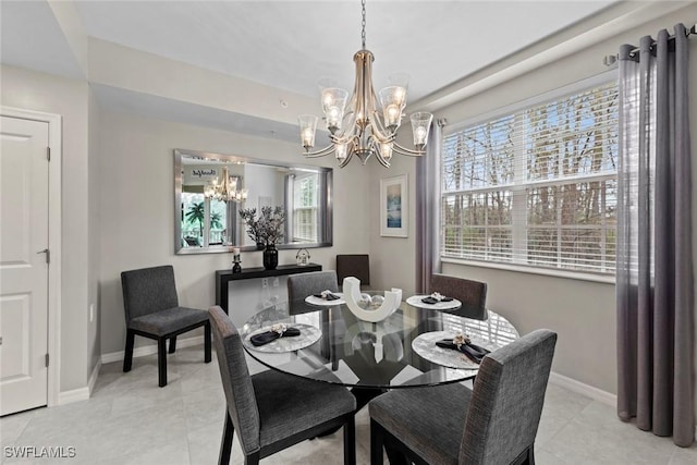 dining room with light tile patterned floors and an inviting chandelier