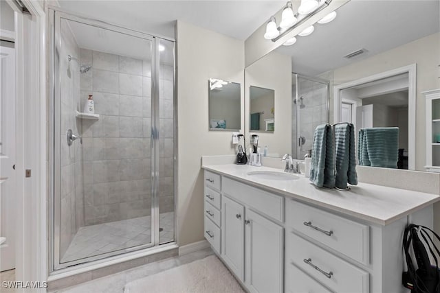 bathroom with vanity and an enclosed shower