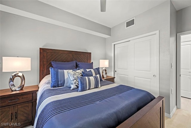 bedroom featuring ceiling fan, light colored carpet, and a closet