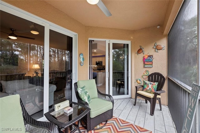 sunroom / solarium featuring ceiling fan